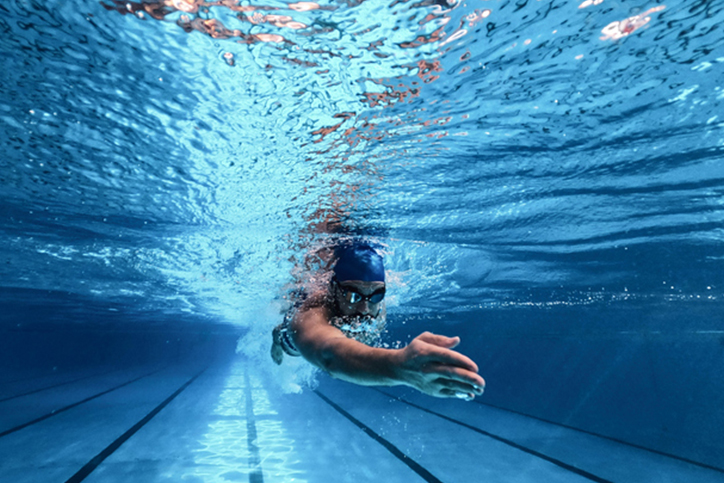 Underwater view of swimmer in a fitness pool.